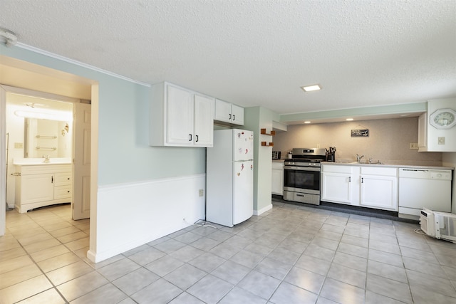 kitchen with a textured ceiling, white cabinetry, and white appliances