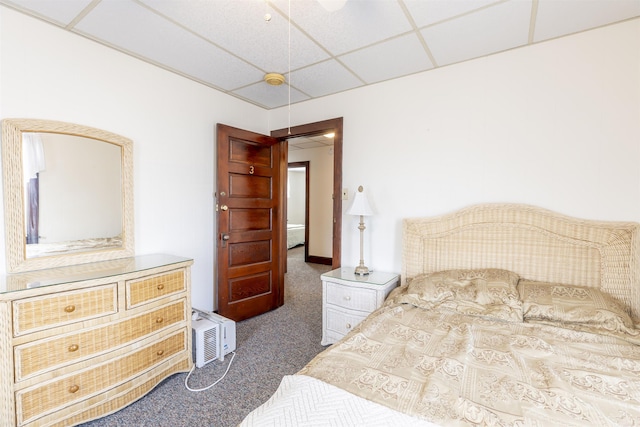 carpeted bedroom featuring a drop ceiling