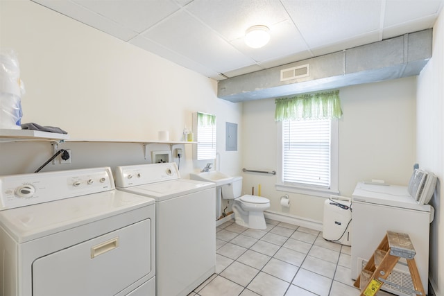 washroom featuring washer and clothes dryer, light tile patterned flooring, sink, and electric panel