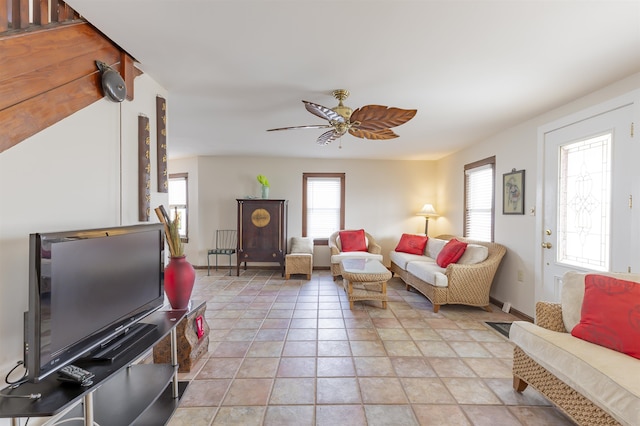 tiled living room with ceiling fan