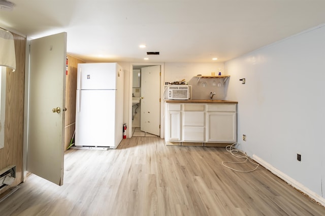 kitchen featuring white fridge and light hardwood / wood-style floors