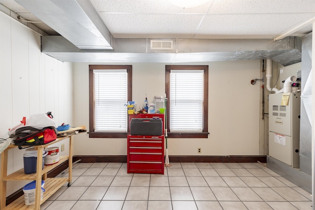 interior space featuring a drop ceiling and a healthy amount of sunlight