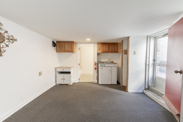 interior space with dark colored carpet and washer / dryer