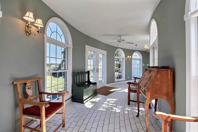 sunroom / solarium with ceiling fan and french doors