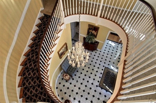 stairway featuring a chandelier