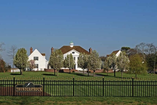 view of property's community with a lawn