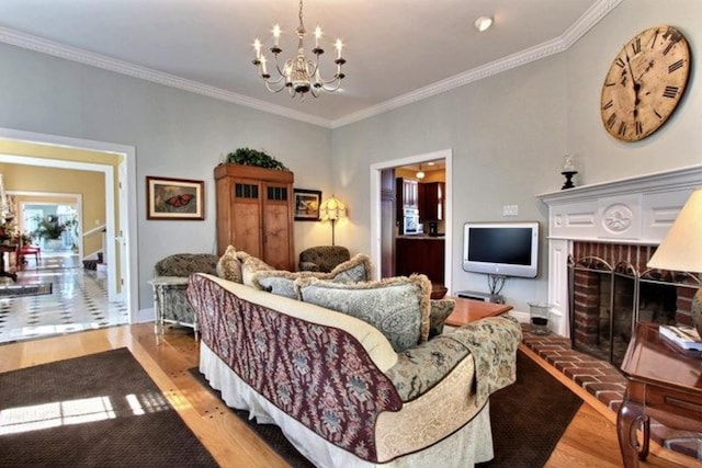 living room with a fireplace, light hardwood / wood-style flooring, an inviting chandelier, and crown molding