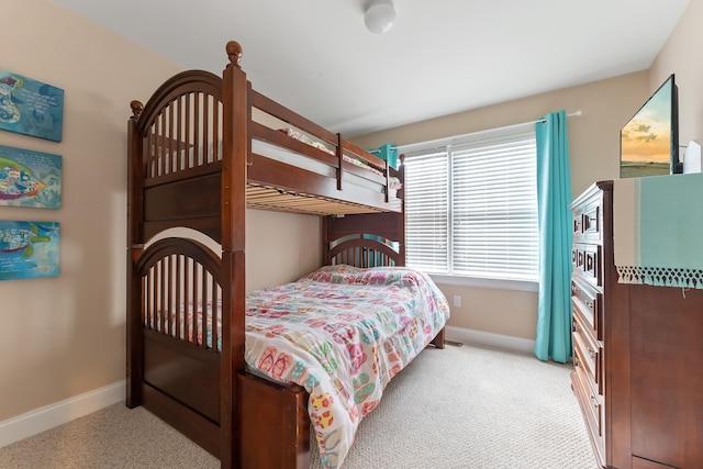 bedroom with baseboards and carpet flooring