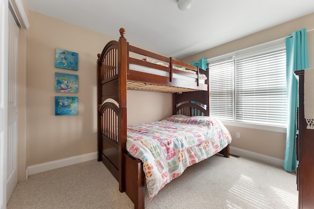 carpeted bedroom featuring baseboards