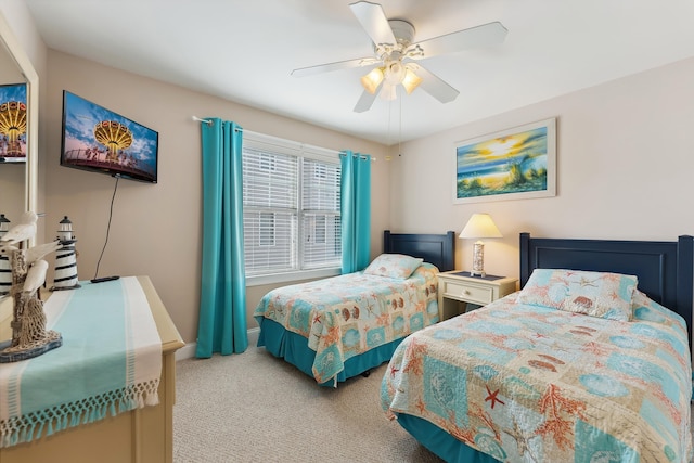 bedroom with light colored carpet, ceiling fan, and baseboards