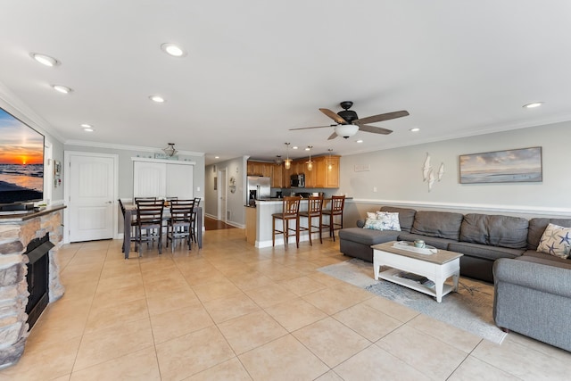 living room featuring light tile patterned floors, ceiling fan, crown molding, and recessed lighting