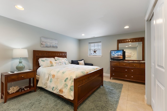 bedroom featuring light tile patterned floors, baseboards, and recessed lighting