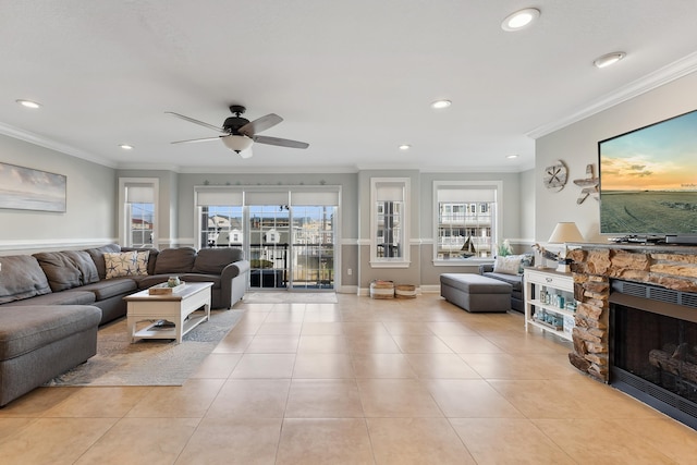 living area with ornamental molding, a healthy amount of sunlight, a fireplace, and light tile patterned floors