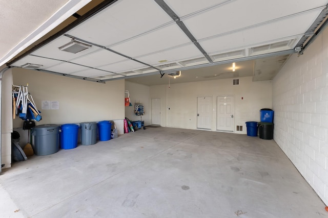 garage featuring visible vents and concrete block wall