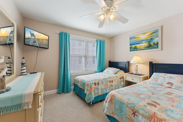 bedroom with a ceiling fan, light colored carpet, and baseboards