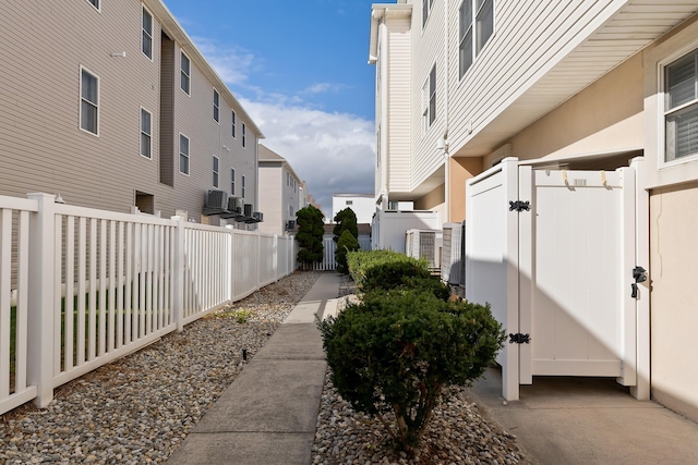 exterior space featuring a residential view, fence, and a gate