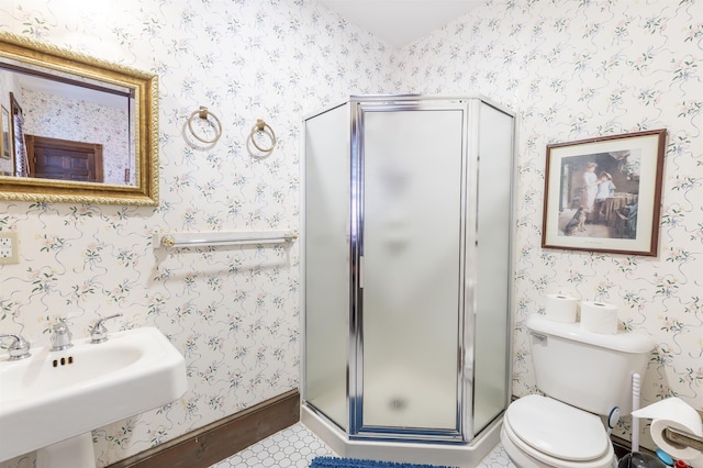 bathroom with tile patterned floors, toilet, a shower with shower door, and sink