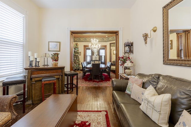 living room featuring dark hardwood / wood-style floors and an inviting chandelier