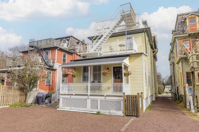 view of front of home featuring covered porch and a balcony