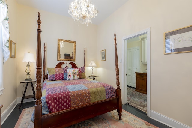 bedroom with dark hardwood / wood-style floors and an inviting chandelier