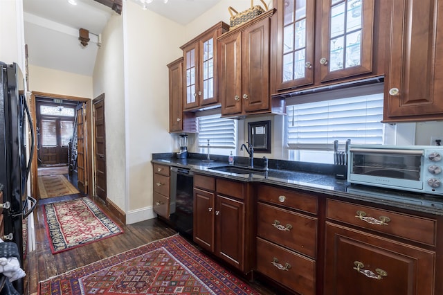 kitchen with black appliances, dark hardwood / wood-style floors, a healthy amount of sunlight, and sink