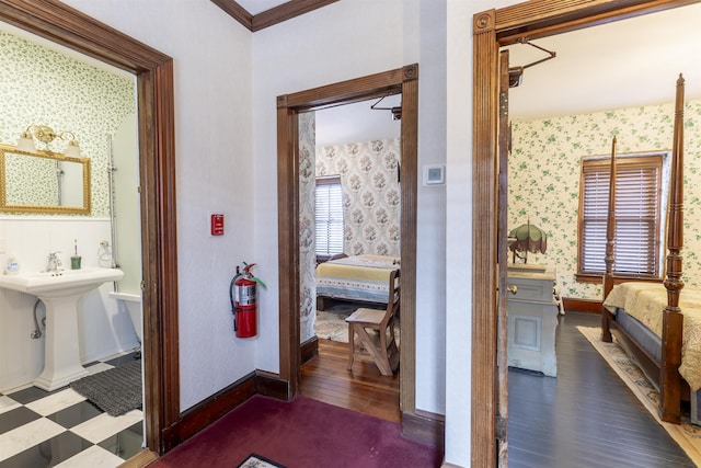 bathroom with wood-type flooring and ornamental molding