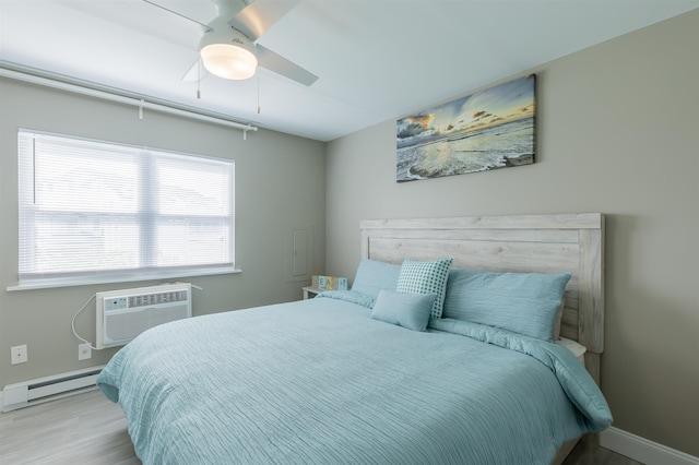 145 Seaview Ct Unit A7, North Wildwood, NJ 08260 - bedroom featuring baseboard heating, wood finished floors, a wall unit AC, and baseboards