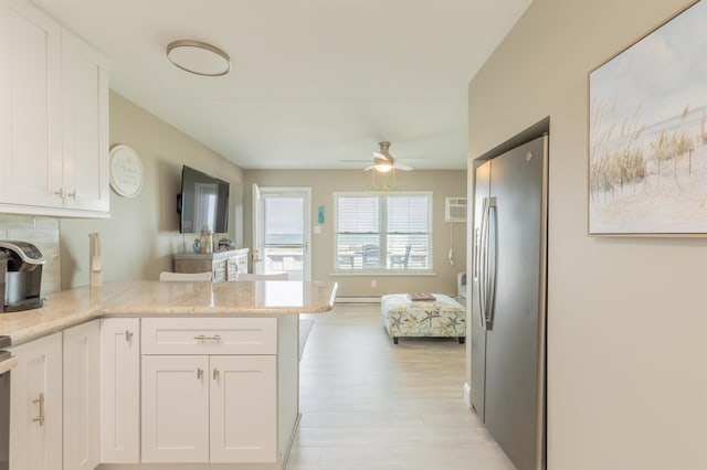 145 Seaview Ct Unit A7, North Wildwood, NJ 08260 - kitchen with freestanding refrigerator, a peninsula, light wood-style floors, white cabinetry, and ceiling fan