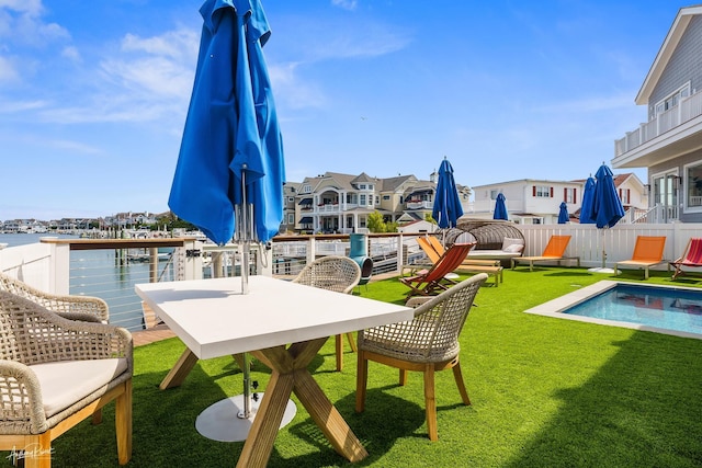 exterior space featuring a fenced in pool and a water view