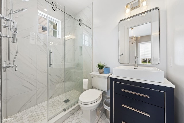 bathroom featuring walk in shower, vanity, and toilet