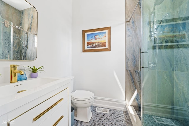 bathroom featuring vanity, toilet, and a shower with shower door