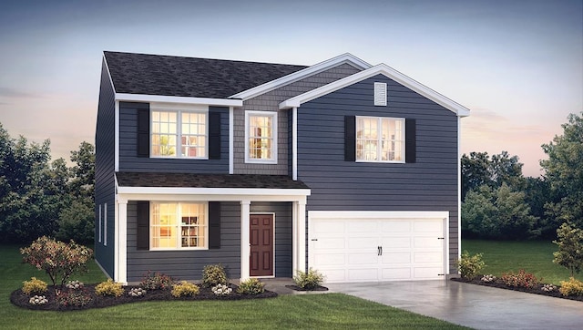 view of front of property featuring a garage and a yard