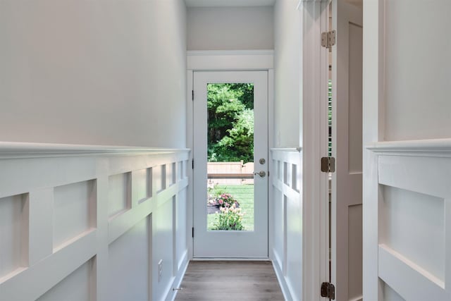 doorway to outside with plenty of natural light and wood finished floors