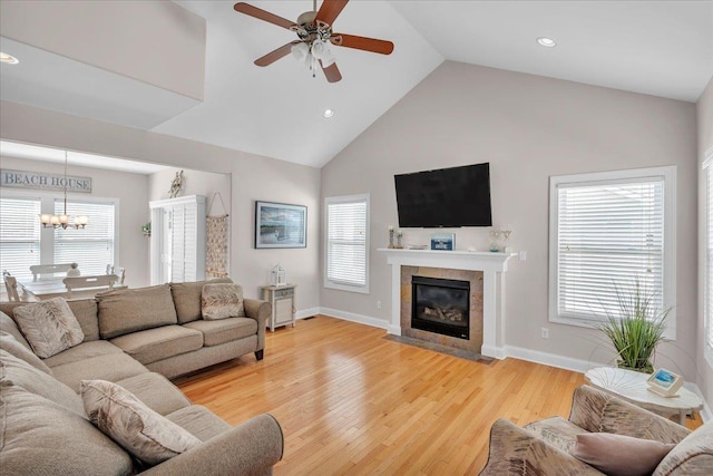 102 E 8 Th Ave, North Wildwood, NJ 08260 - living area featuring high vaulted ceiling, ceiling fan, a tiled fireplace, a chandelier, and light wood-type flooring