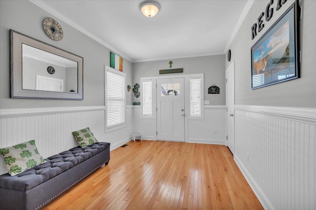 102 E 8 Th Ave, North Wildwood, NJ 08260 - foyer featuring wainscoting, light wood-style floors, and ornamental molding