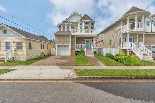 102 E 8 Th Ave, North Wildwood, NJ 08260 - view of front of home with driveway, stairway, an attached garage, a balcony, and a porch
