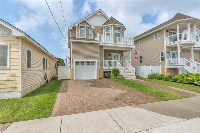 102 E 8 Th Ave, North Wildwood, NJ 08260 - view of front of property with a garage, decorative driveway, a porch, stairway, and a balcony