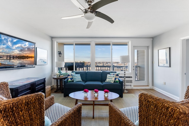 living room with ceiling fan and light wood-type flooring