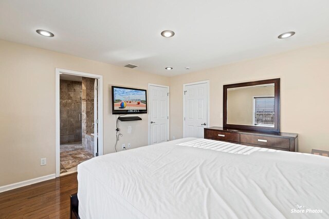 bedroom with dark hardwood / wood-style floors