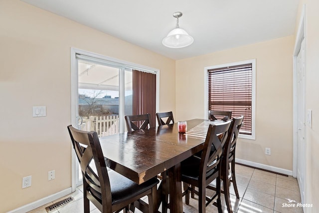 dining area with light tile patterned floors