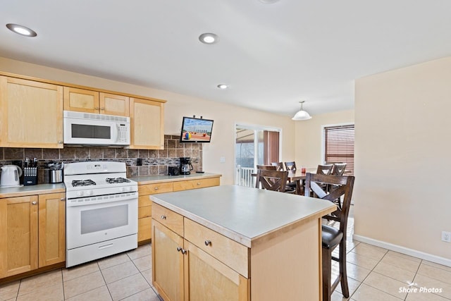 kitchen featuring decorative backsplash, white appliances, light tile patterned flooring, and a kitchen island