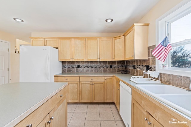 kitchen with sink, light brown cabinets, light tile patterned floors, white appliances, and decorative backsplash