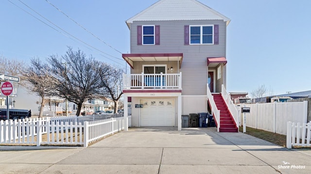 view of front of house featuring a balcony and a garage