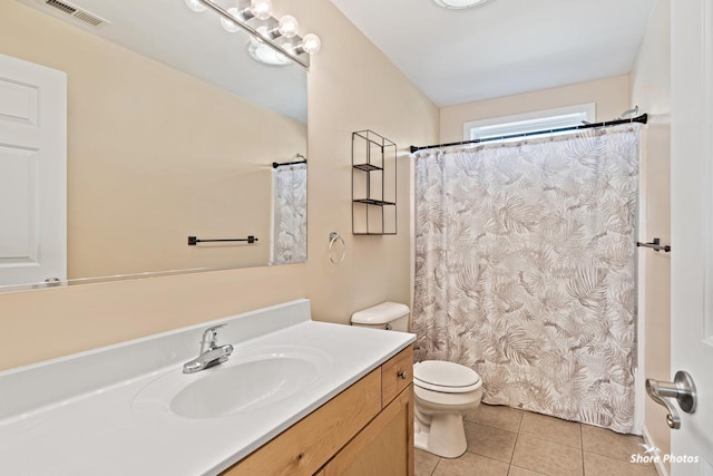 bathroom with tile patterned floors, toilet, and vanity