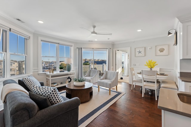 living room featuring ceiling fan, dark hardwood / wood-style flooring, and ornamental molding