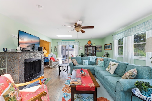 2710 Bybrook Dr, Cape May Beach, NJ 08251 - living room with a ceiling fan, plenty of natural light, light wood-type flooring, and a tiled fireplace