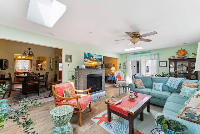 2710 Bybrook Dr, Cape May Beach, NJ 08251 - living area featuring light wood finished floors, a fireplace, a ceiling fan, and a chandelier