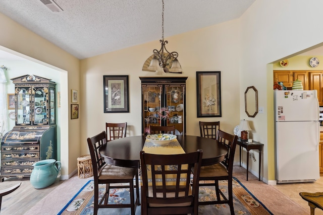 2710 Bybrook Dr, Cape May Beach, NJ 08251 - dining space with vaulted ceiling, a chandelier, and a textured ceiling