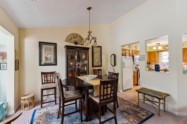 2710 Bybrook Dr, Cape May Beach, NJ 08251 - dining room featuring a textured ceiling, lofted ceiling, and light carpet