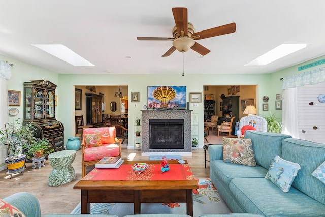 2710 Bybrook Dr, Cape May Beach, NJ 08251 - living room featuring a skylight, wood finished floors, a fireplace, and a ceiling fan